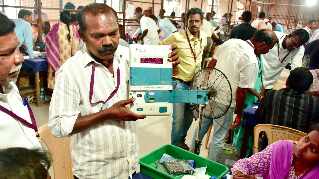 Election official demonstrates an EVM during vote counting in Madurai. Pic/PTI